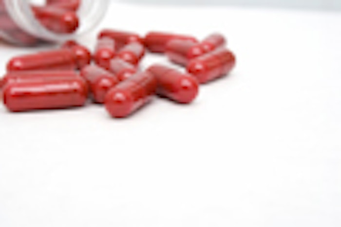 Closeup of red capsules on white background