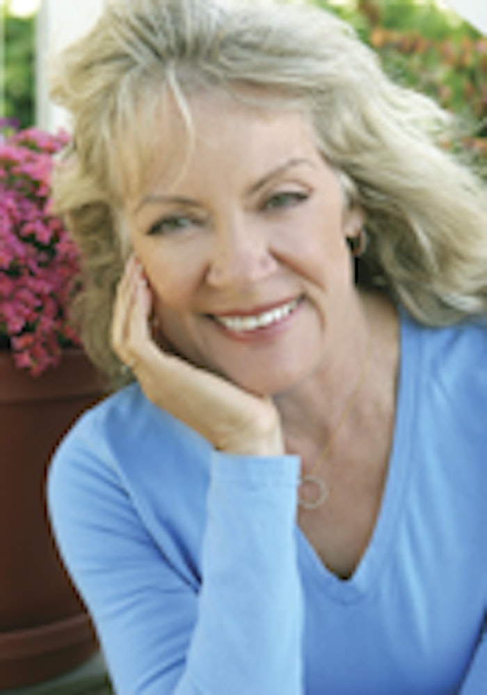 A portrait of a beautiful mature blond woman smiling.