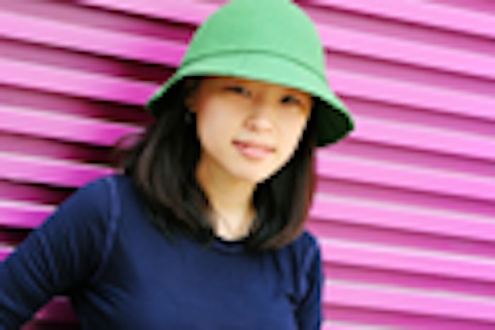Pretty Korean woman wearing a green hat and navy blue top