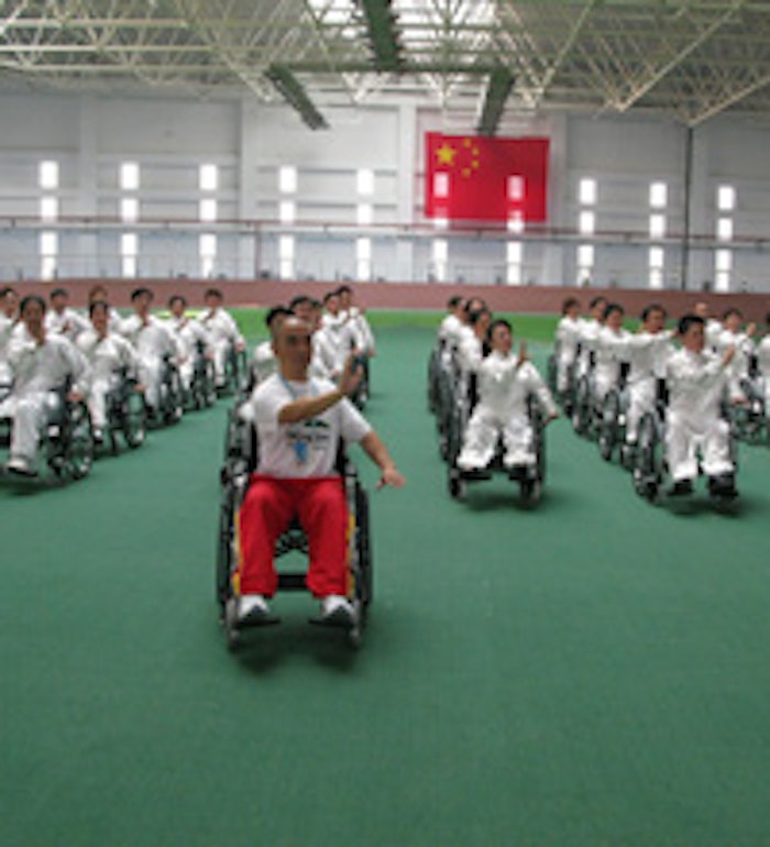 Alhough he does not use a wheelchair for mobility, Dr. Zibin Guo used the device to demonstrate an innovative Tai Chi technique for a group in China.
