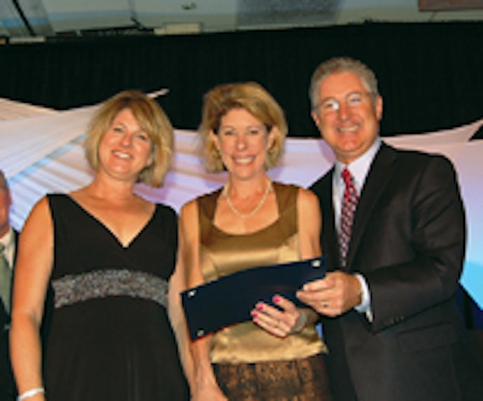 From left, Michele Pribble, marketing director, and Lisa Jenks, MD, medical director from Genesis Medspa accept the award from Jon Carrol for Excellence in Customer Service 2010.