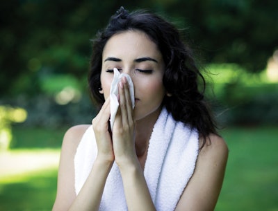 Woman with sniffles outdoors