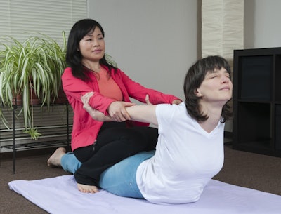 woman receiving thai massage