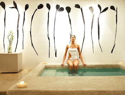 woman soaking legs in spa pool