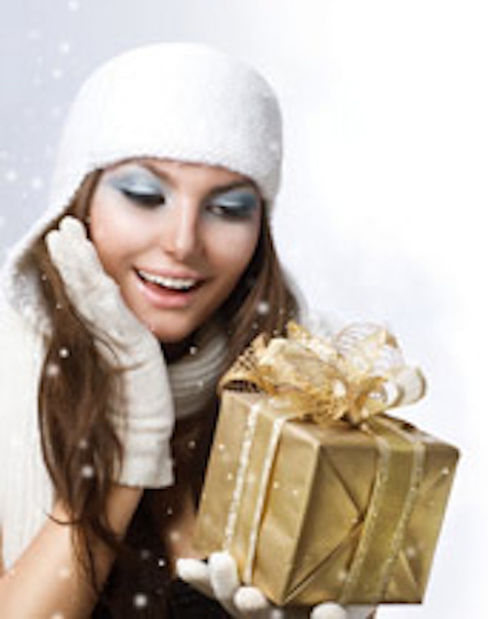 Beautiful Happy Girl with Christmas Gift. Snow