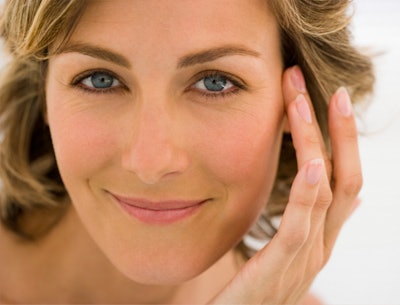 woman with hand to temple