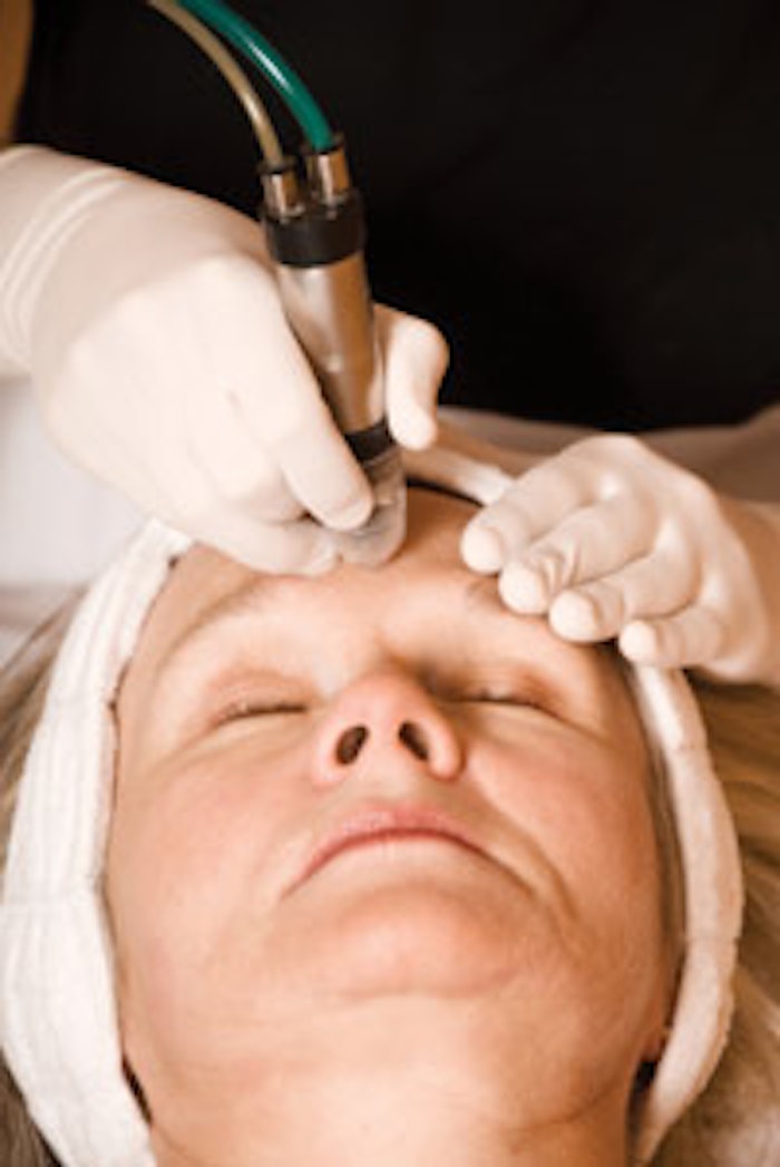 A rough-surfaced instrument is used to polish the skin during the performance of microdermabrasion.
