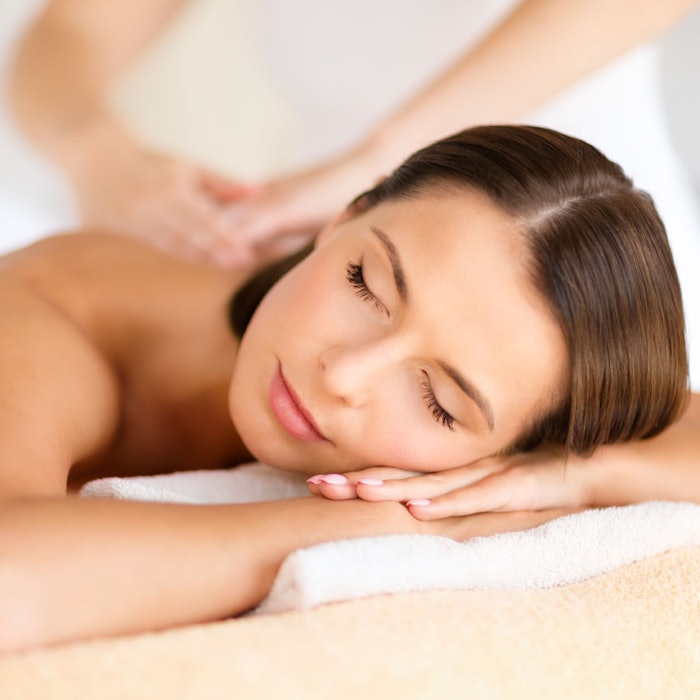 beautiful woman in spa salon getting massage