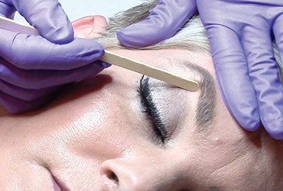 Even though hard wax doesn’t stick to the skin, it can still create that “bounce back” if skin is not held taut and the hand is not kept parallel to the skin on removal. When removing wax around the eyes and lips, keep the skin taut all along the removal path by taking shorter pulls to remove the wax, adjusting your hand after each pull to keep the skin taut. This will help protect the skin from “bouncing back” and damaging the underlying structures.