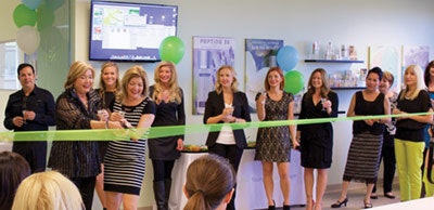 Rhonda Allison cutting a ribbon