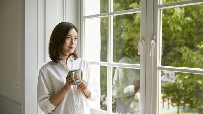 woman looking out window and smiling