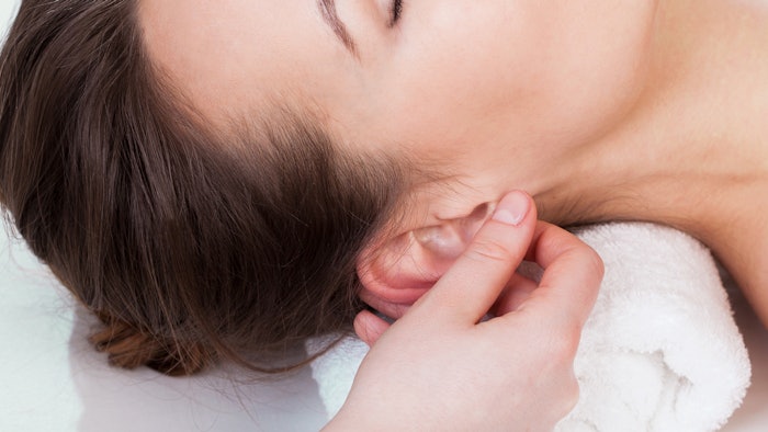 Woman massaging ear