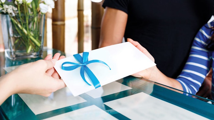Woman handing customer gift