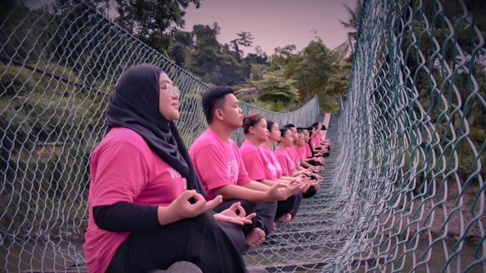 In Malaysia, a group celebrates Global Wellness Day with a nature meditation.