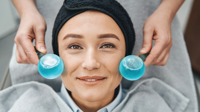 woman getting cooling globe treatment
