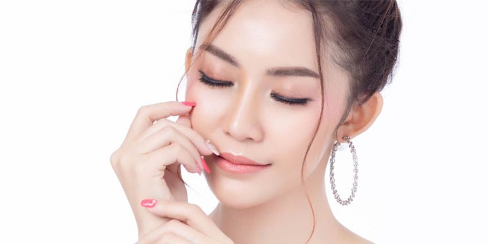 Layering eyeshadow, curling eyelashes, fake lashes and warm-toned brow colors are some tips from makeup artists for Asian features, according to Forbes.