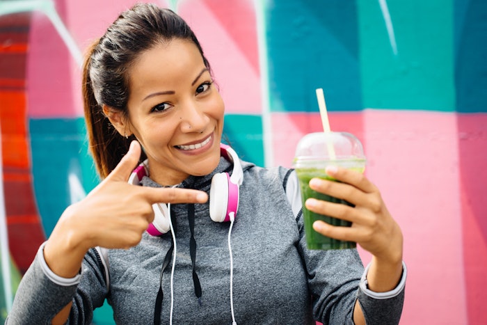 Woman drinking a smoothie after working out