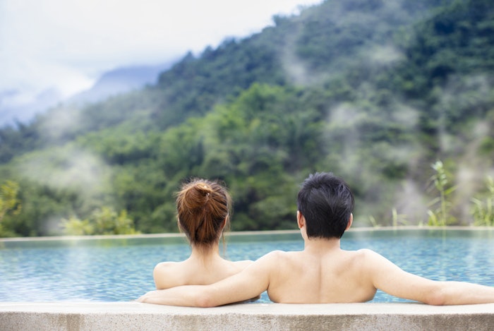 Couple relaxing in outdoor hot springs