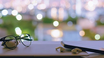 Glasses and a phone with earbuds