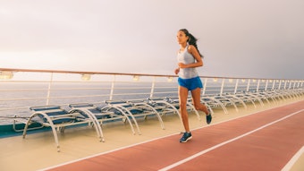 Woman running on a track on board a cruise ship