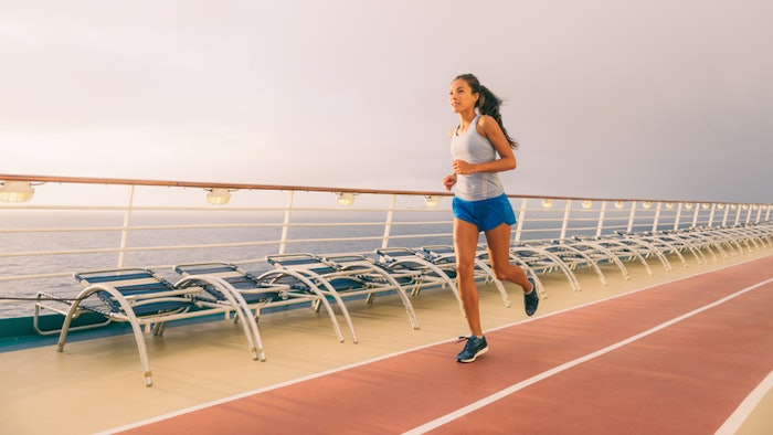 Woman running on a track on board a cruise ship