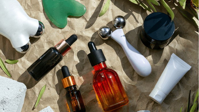 Face roller, microcurrent, gouache scraper, cosmetic on craft paper background