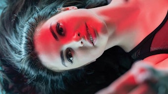 Woman under red light