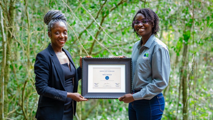 Representing the Wellness Committee of Antigua & Barbuda, Maria Blackman presents the WTA Leading Light Award to Refica Attwood, founder and executive director of Wallings Nature Reserve