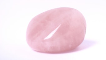 rose quartz stone on a white background