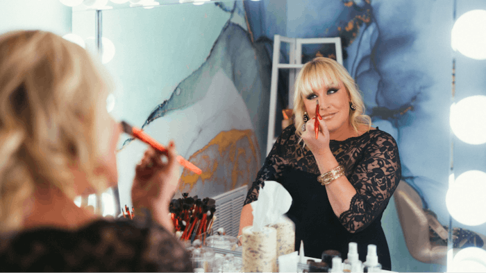 Melanie Mills Applying Makeup in her beauty boutique