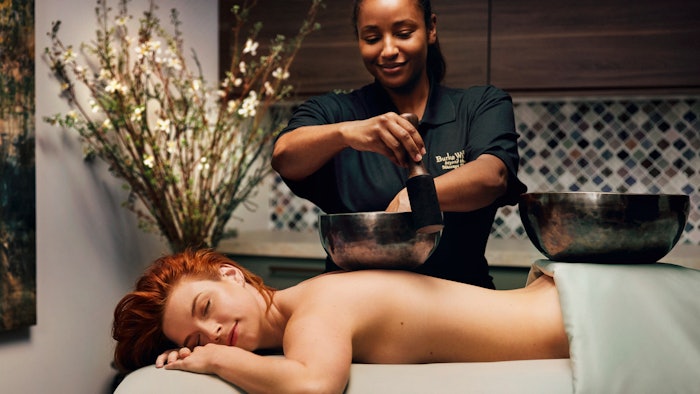 woman receiving sound therapy massage spa treatment