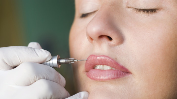 Woman having permanent pigment tattooed into the skin's upper dermal.