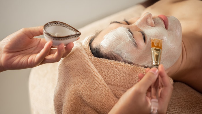 woman receiving probiotic facial treatment at the spa
