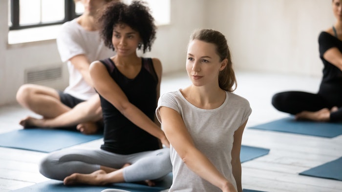 women performing yoga in a class