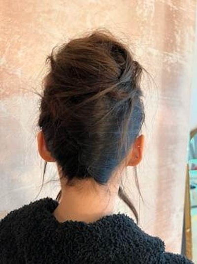 Dove Cameron's messy French twist styled by Jacob Rozenberg.