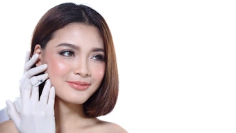 Woman getting injection in her jawline