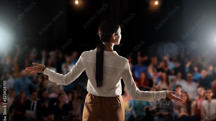Woman speaking on stage