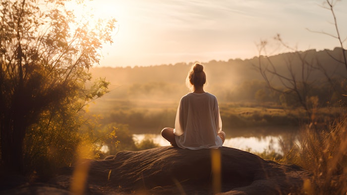 girl meditating during sunrise