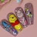 Winnie the Pooh and Piglet nail art featuring butterflies and bumblebees by @keepinittreal