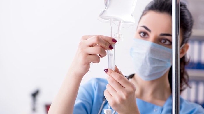 young female nurse administrating IV nutritional therapy