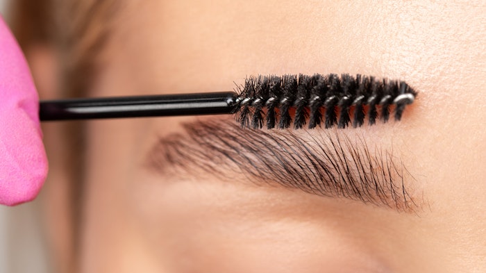 Woman brushing through brows