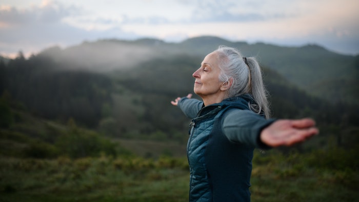 Woman on the top of a mountain