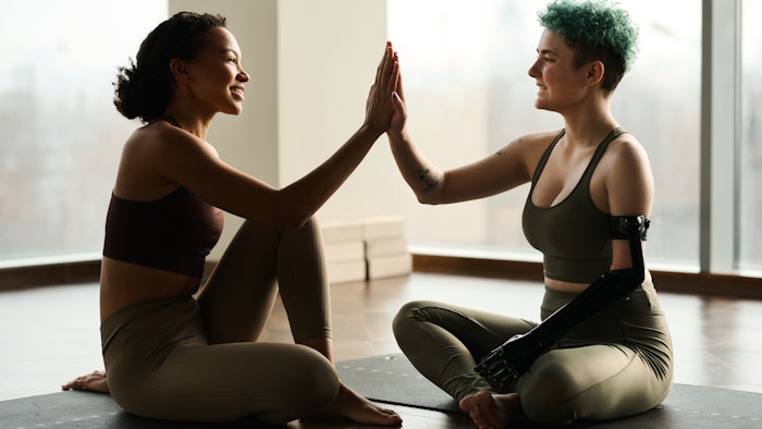 Women high-fiving after yoga.