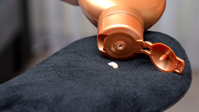 mitten for self-tanning and applying cream for tanning. Concept: skin care, beauty, health.