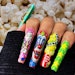 Nail artist Yatzy MC created nail art inspired by the cult classic horror movie Killer Klowns from Outer Space. Learn how to recreate the popcorn nail art part of the set with this tutorial.