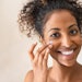 Beautiful girl applying face cream