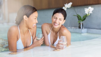 Women laughing in hot tub at spa