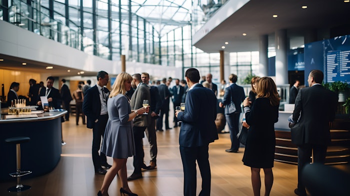 Delegates networking at conference drinks reception, group of business people talking at networking event sharing and discussing new innovation at business conference