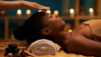 woman receiving reiki healing in the spa