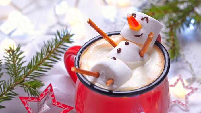 Hot chocolate with marshmallow snowman soaking, hot tub holiday concept